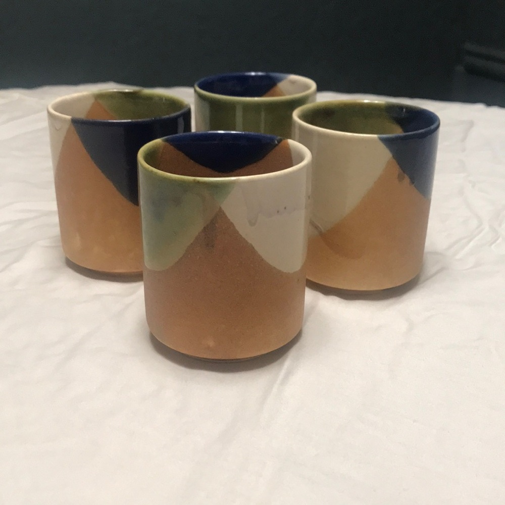 Set of 4 art pottery tea cups.